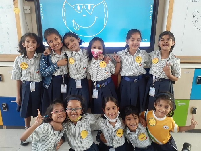 Students with smiley badge