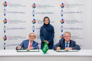 (L to R) - Andre Cointreau, Mayada Badr, and David Henry sign an agreement between Mohammed Bin Salman Nonprofit City and Le Cordon Bleu Arabia Educational Institute